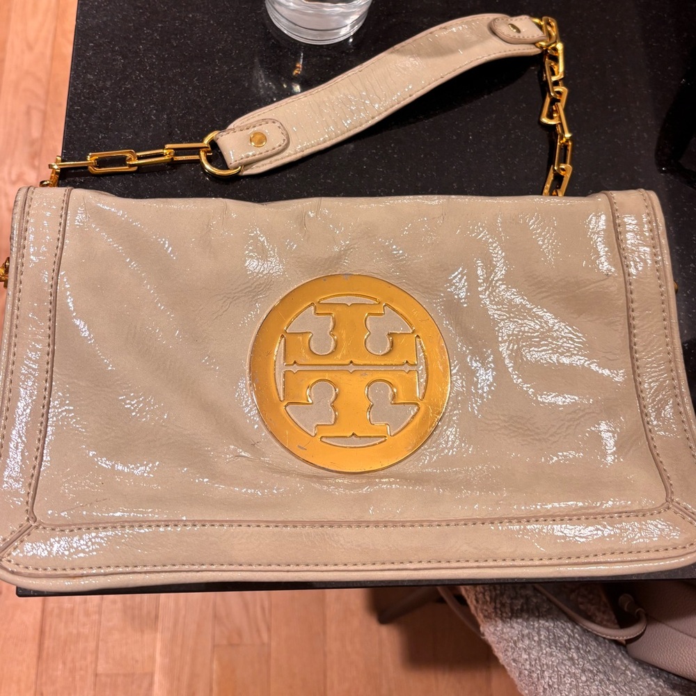Beige Tory Burch flat clutch with gold chain
